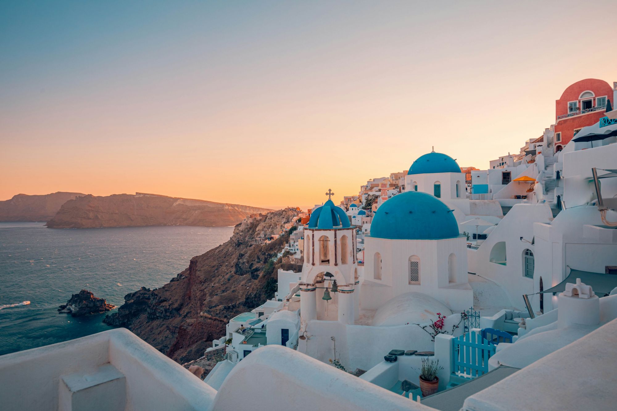 Tramonto sui tetti blu e sugli edifici bianchi del paese di Oia, a Santorini. © icemanphotos/Shutterstock