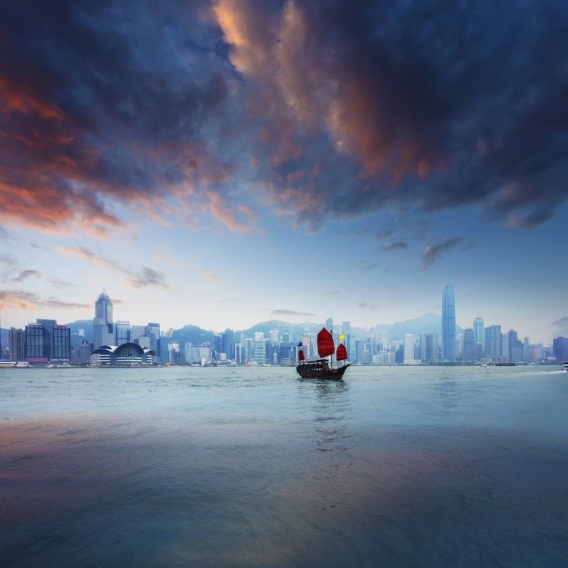 Una giunca cinese tradizionale naviga nel Victoria Harbour al tramonto, Hong Kong © chinaface / Getty Images